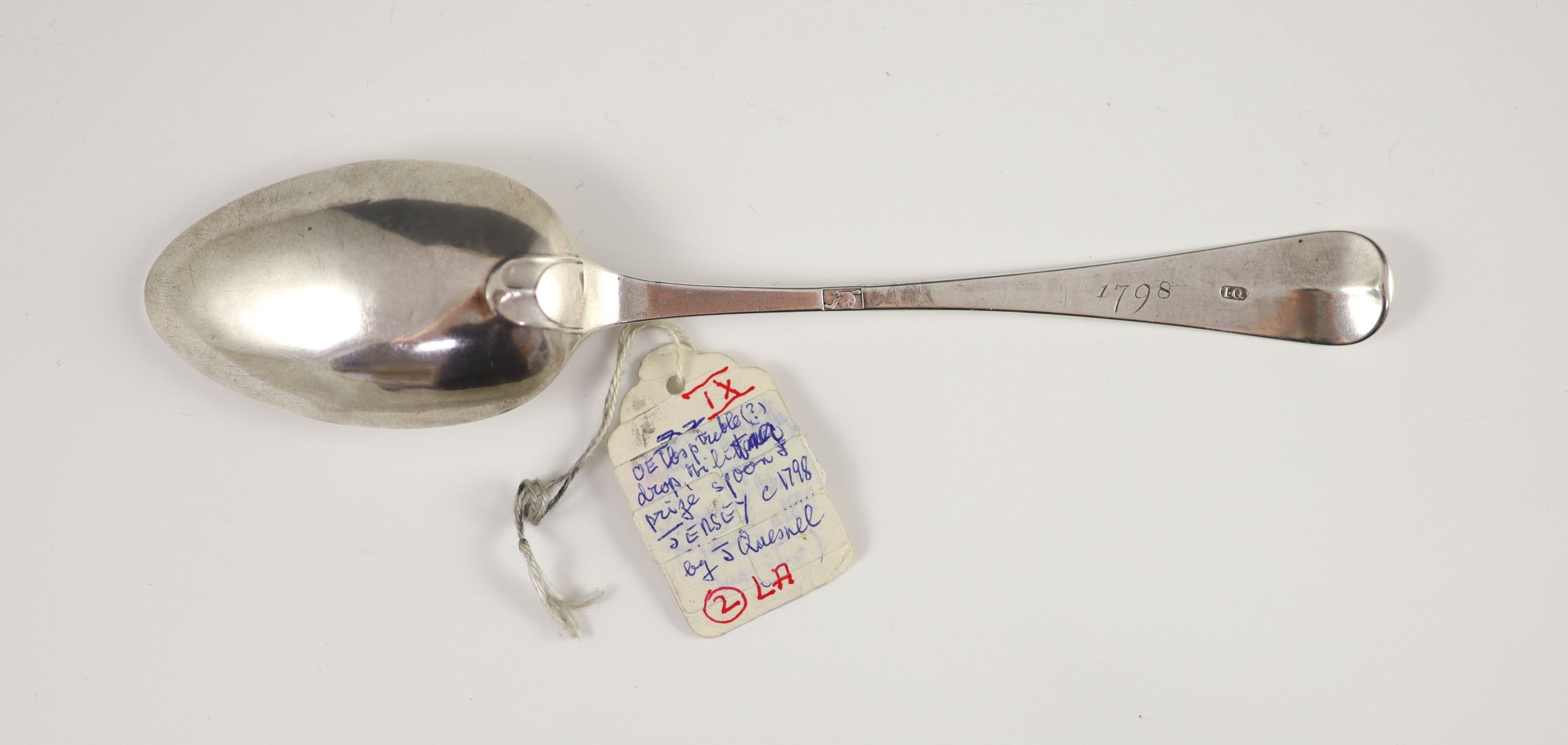 A George III Channel Islands silver tablespoon, initialled ‘S.D.C’ over ‘K.A’, inscribed 1798, attributed to Jacques Quesnel, marked ‘I.Q’ and cannon mark, 20cm long, 1.2 oz.